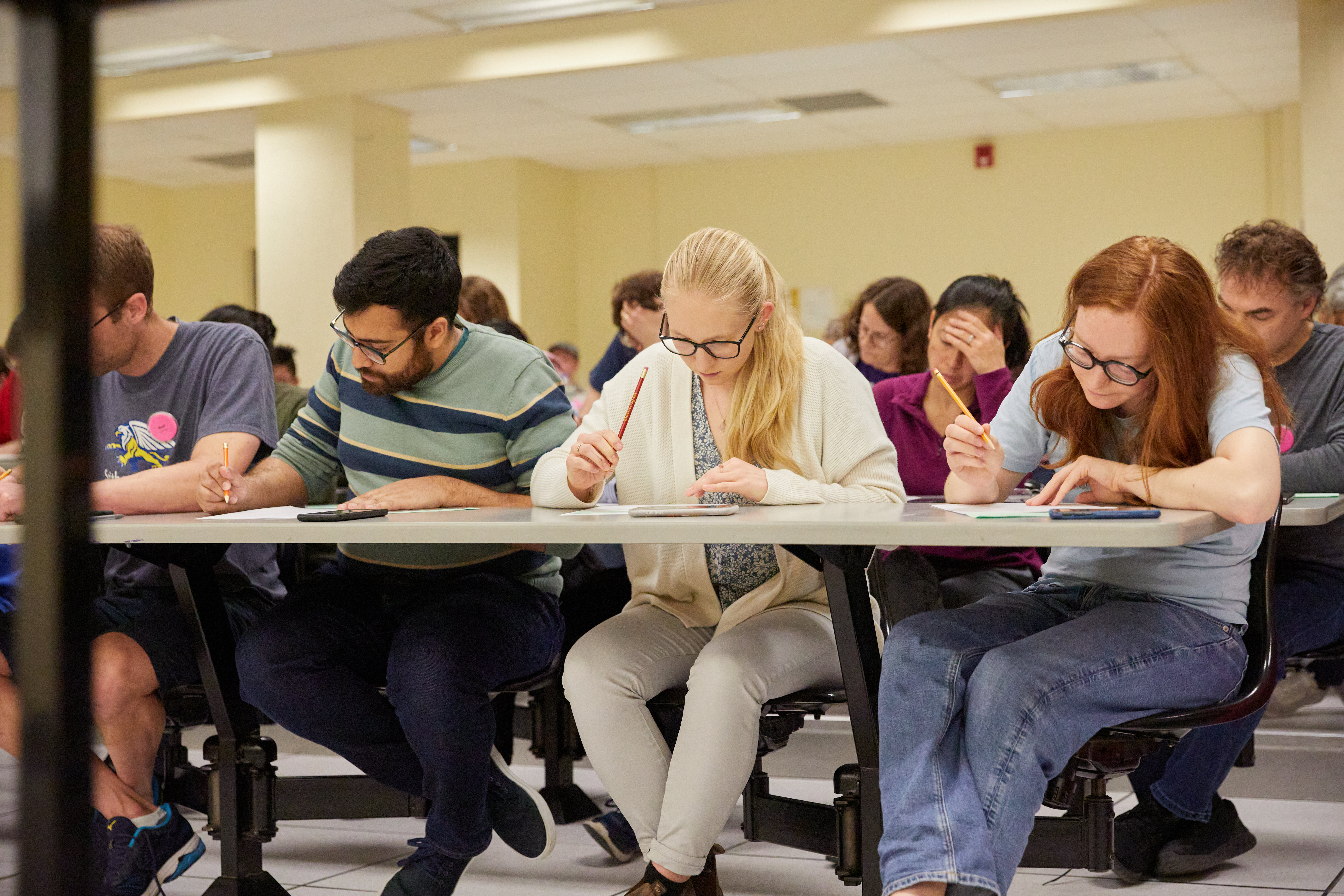 Row of older students taking a math test