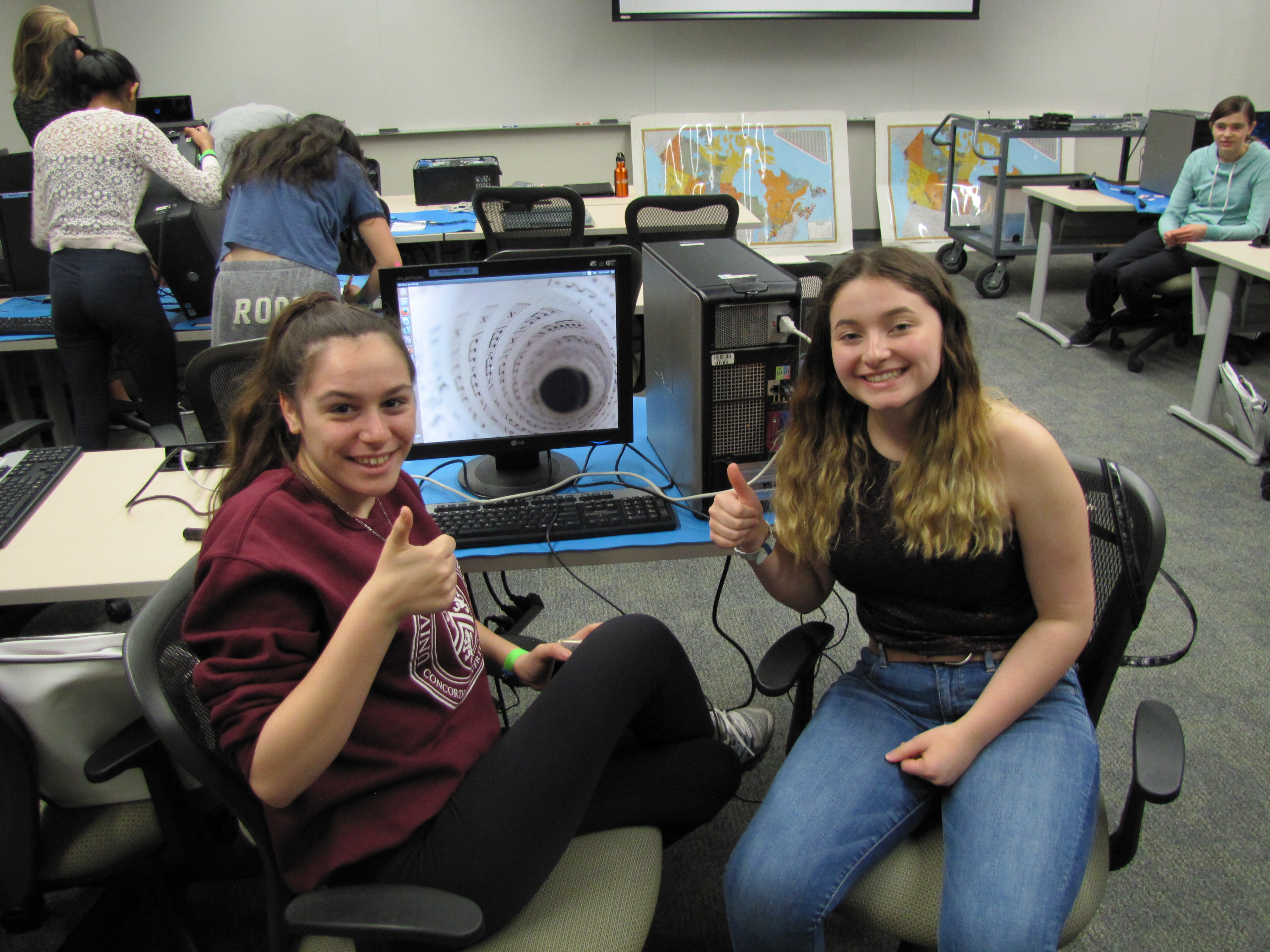 Students in front of a computer at a CEMC computer science workshop