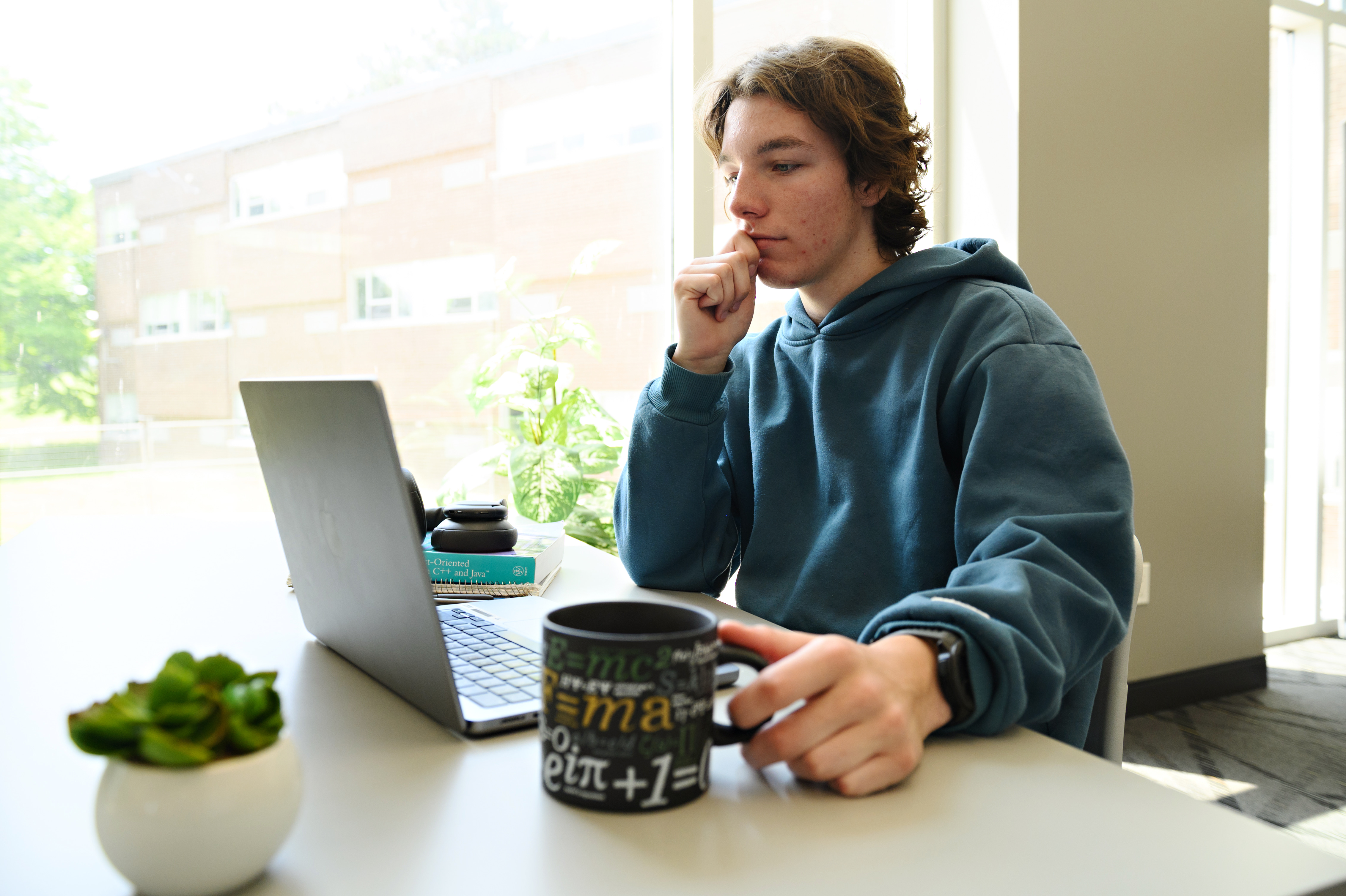 Student looking into their laptop accessing CEMC courseware