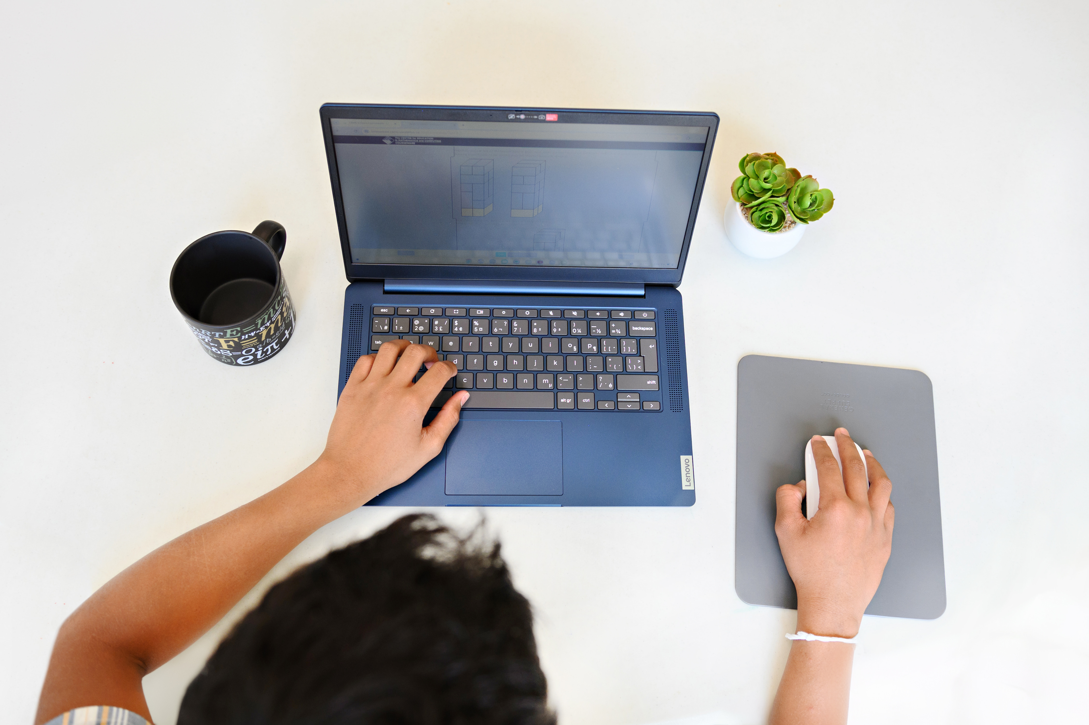 Student working on CEMC courseware on the laptop at home