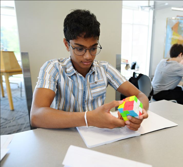 Student using a rubics cube for learning more about problem solving