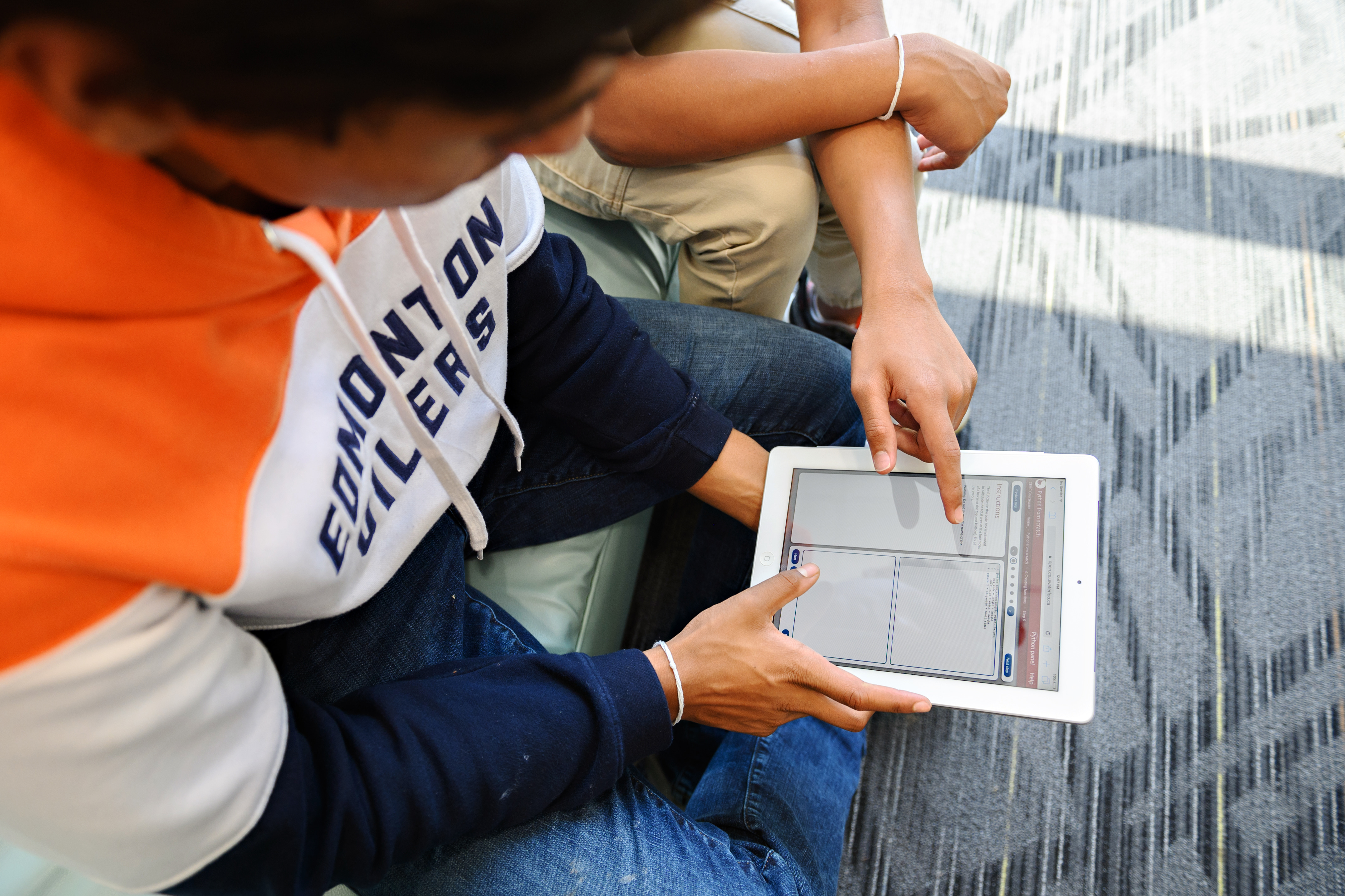 Students trying coding using python on a tablet