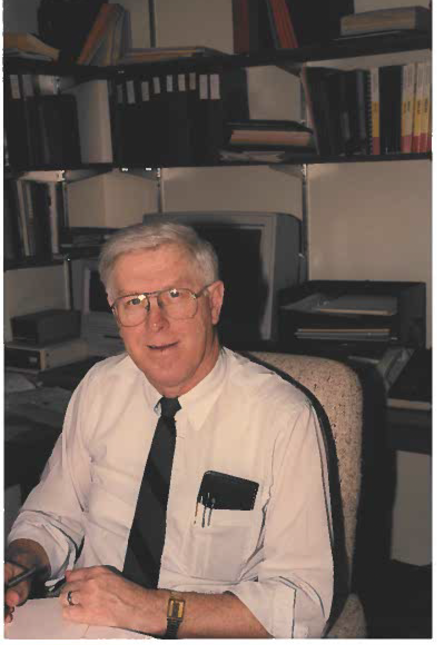 Image of Ron Dunkley sitting at his office desk