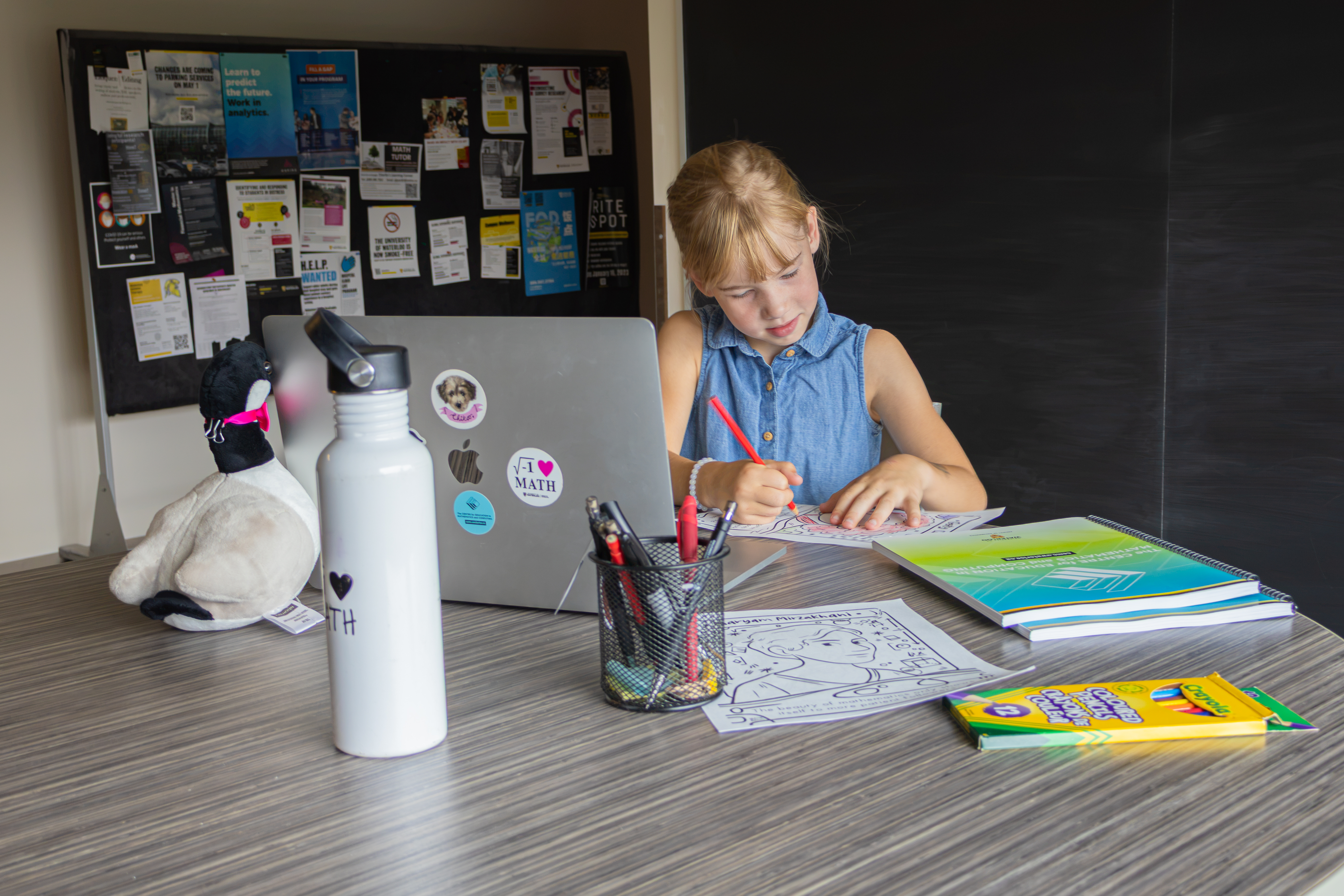 Elementary school student working on online courseware and worksheets.