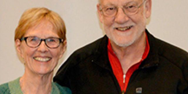 Cathy and Paul Cotton stand together smiling