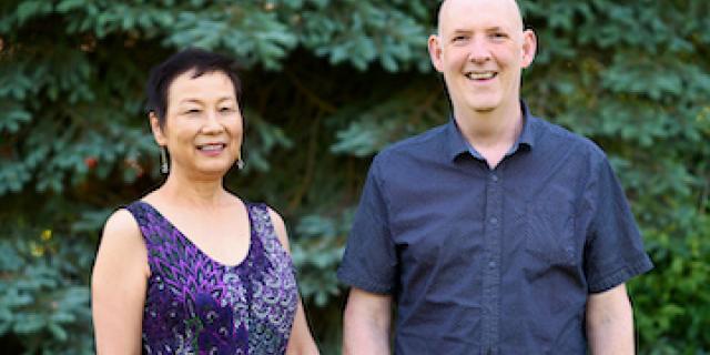 Image of Giesbrecht and Kou in front of a tree smiling