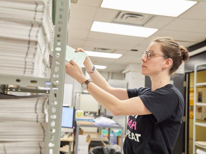 Staff member organising contests on shelves