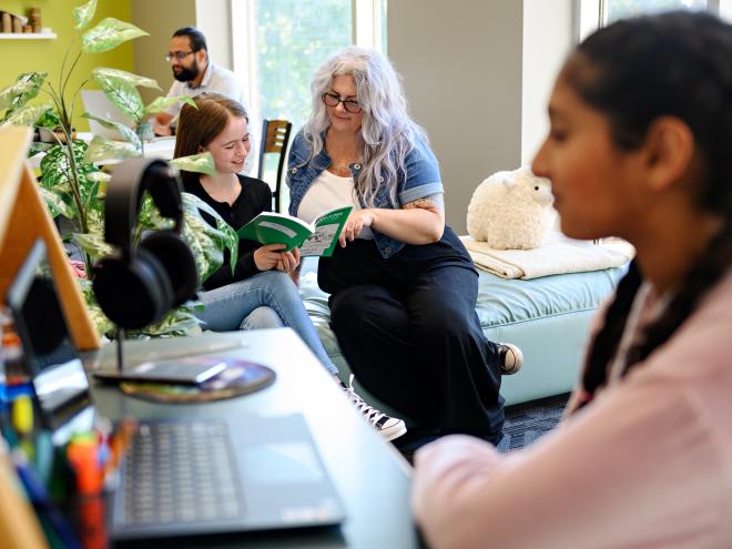 Student working with educator at the school lounge