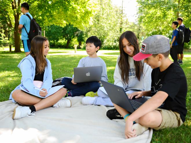 Team of students working together with laptops