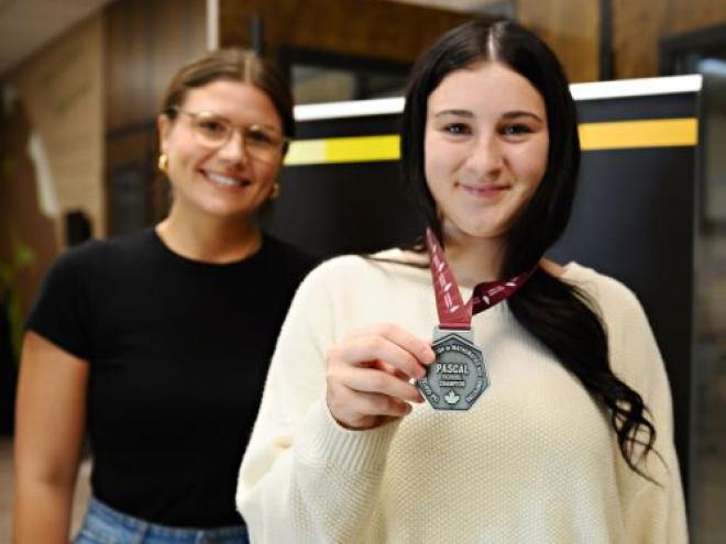 Student with CEMC contest medal along side the teacher